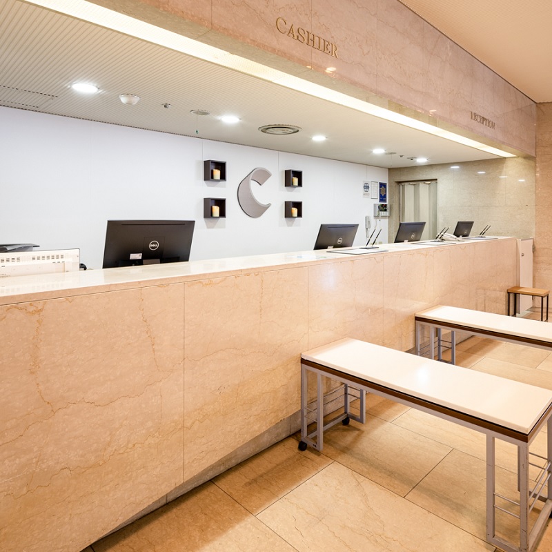 Comfort Hotel Hakata reception desk with Comfort Hotels logo and marble-finish counter