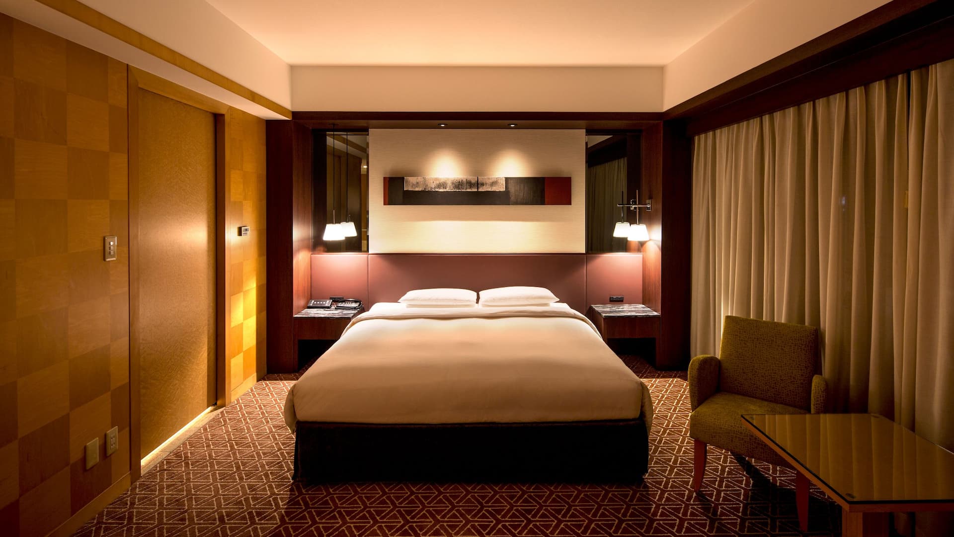Grand King Room with plush seating area and floor-to-ceiling window