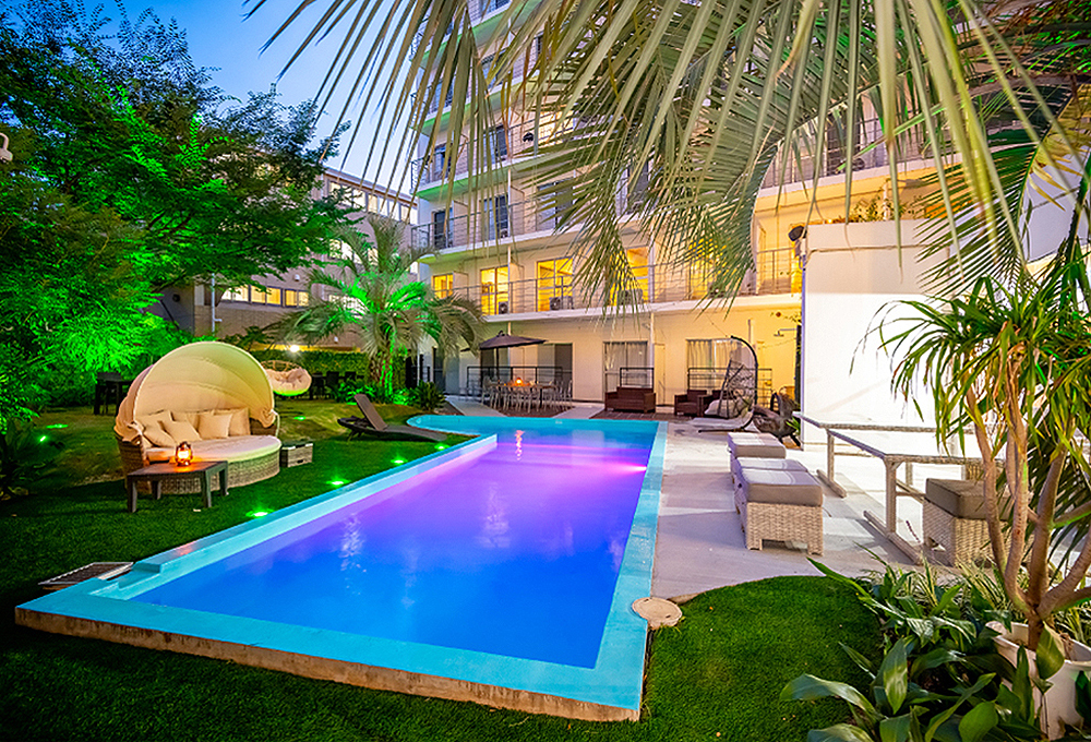 Hotel Japanesque Fukuoka outdoor garden pool with palm trees at night