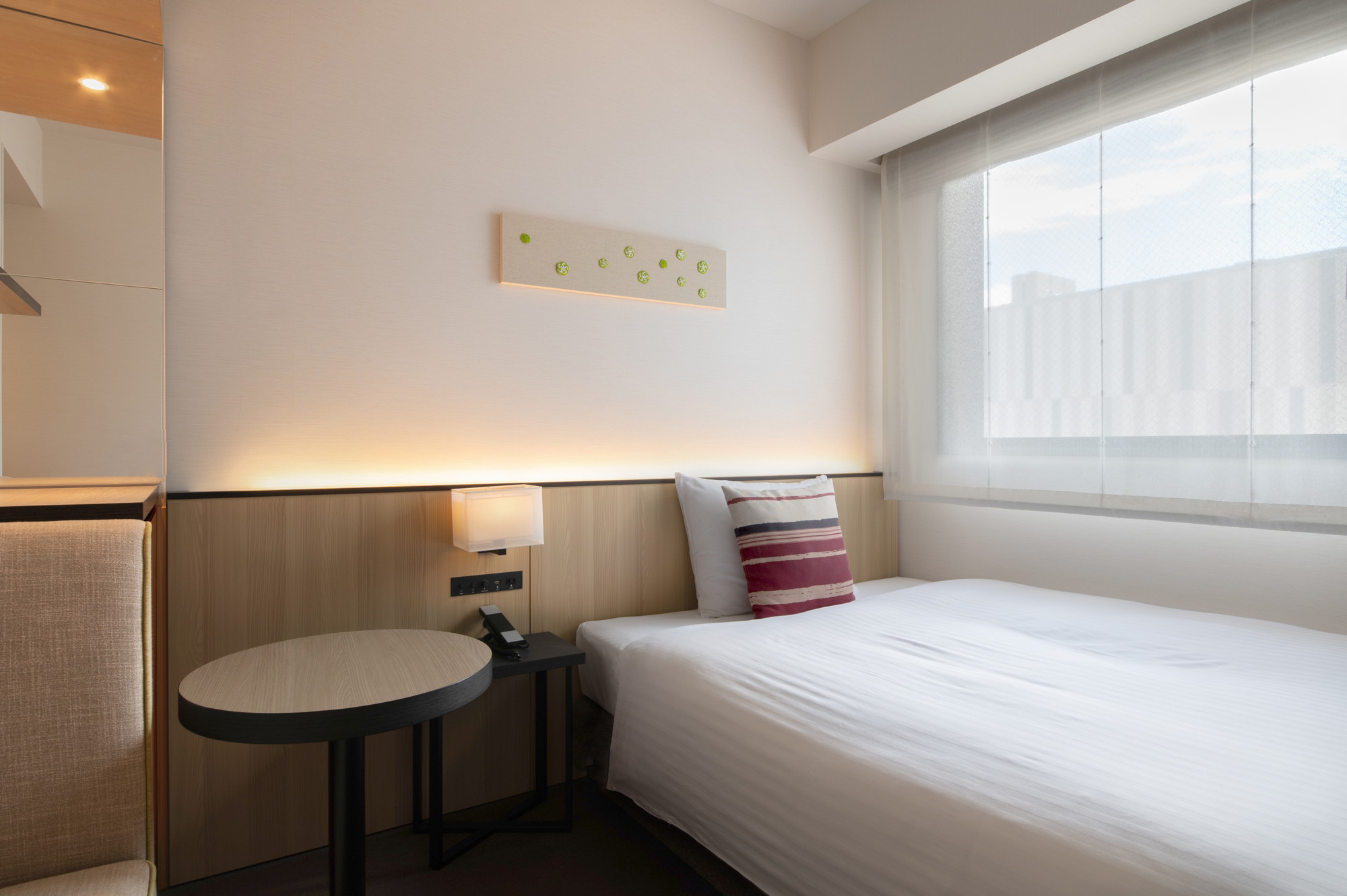 Hotel Vista Fukuoka guest room interior — bed and work area