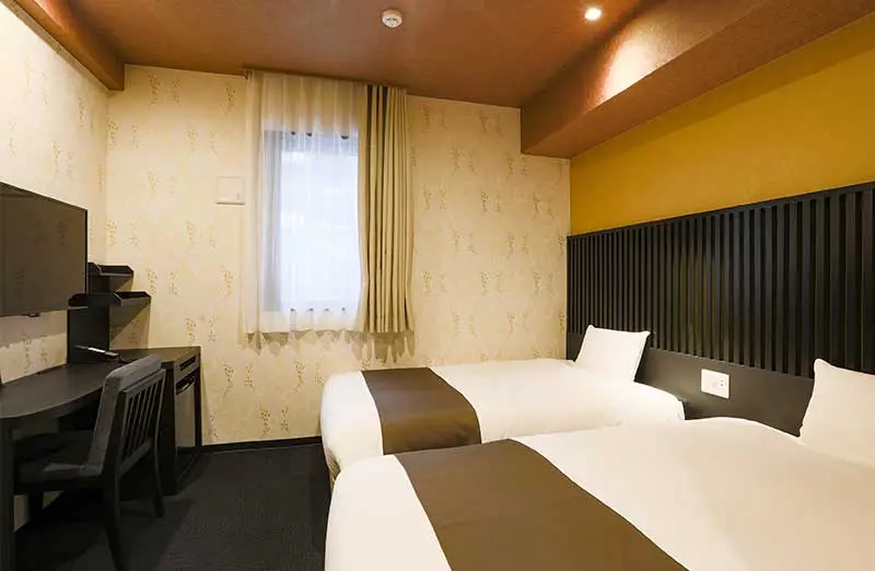 Comfort-tier room at Hotel Wing International Select Hakata Ekimae showing compact but well-organized layout