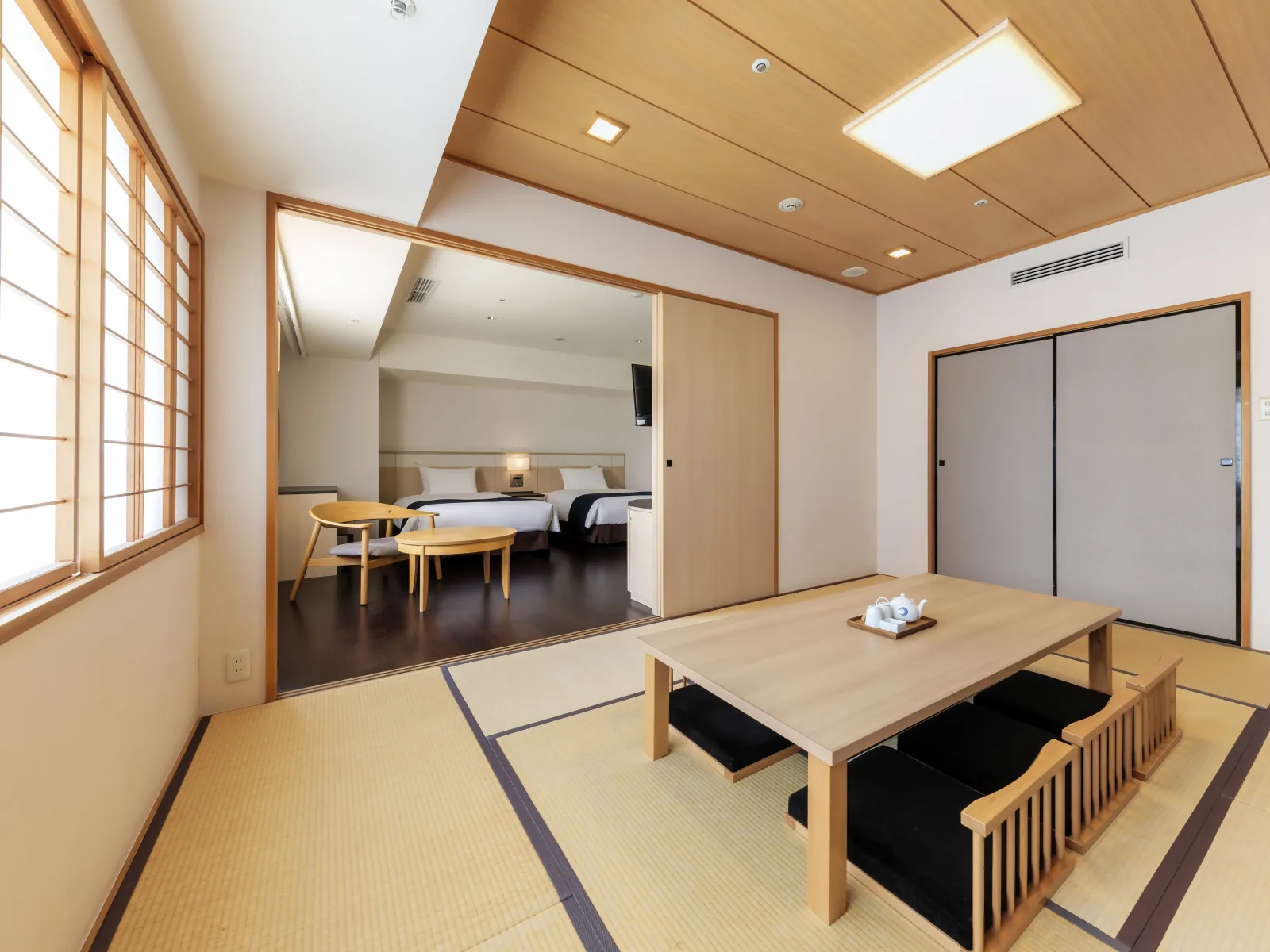 Japanese-Western style room combining tatami seating area with Western-standard bed
