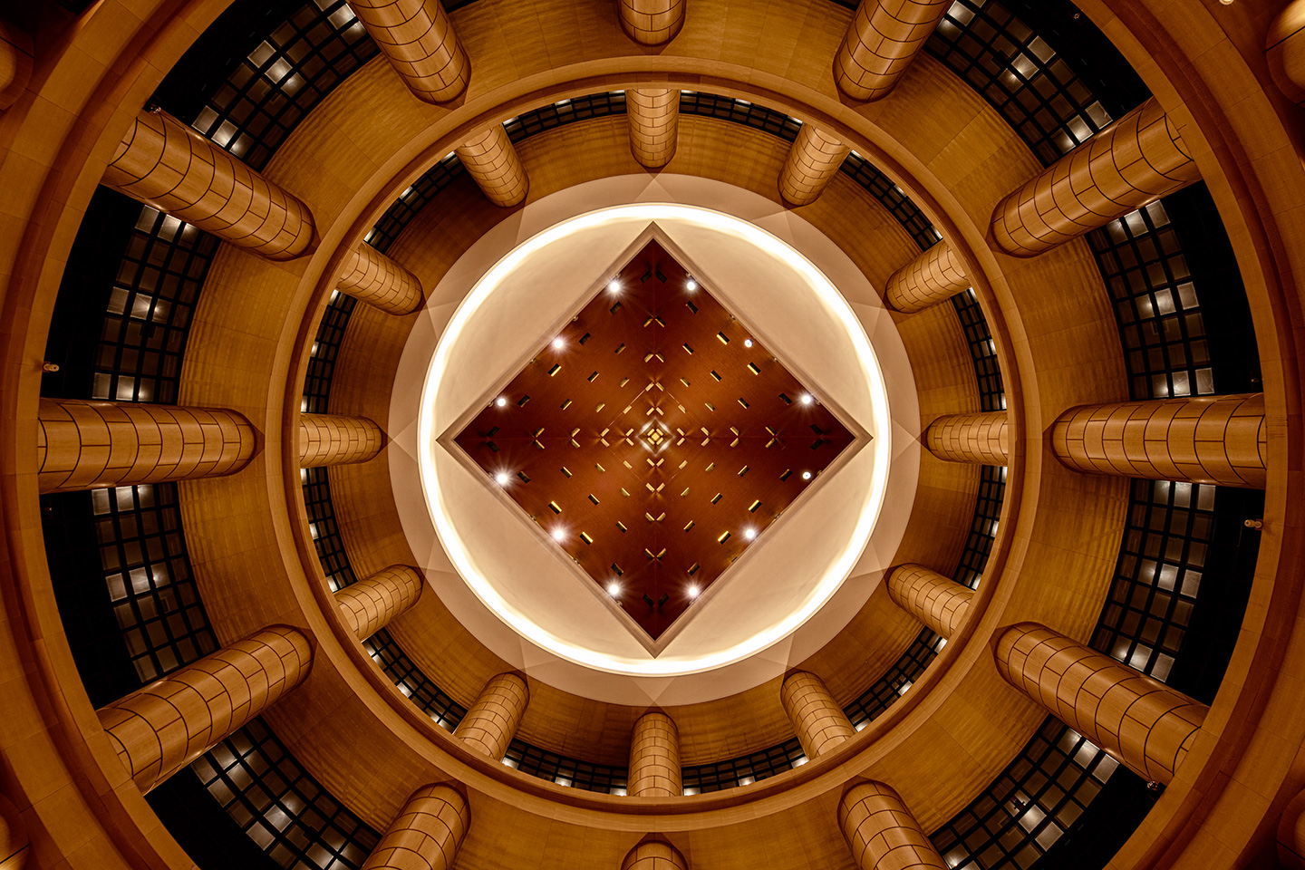 Library atrium at The Basics Fukuoka — alternate angle showing the full height of the book-lined circular space