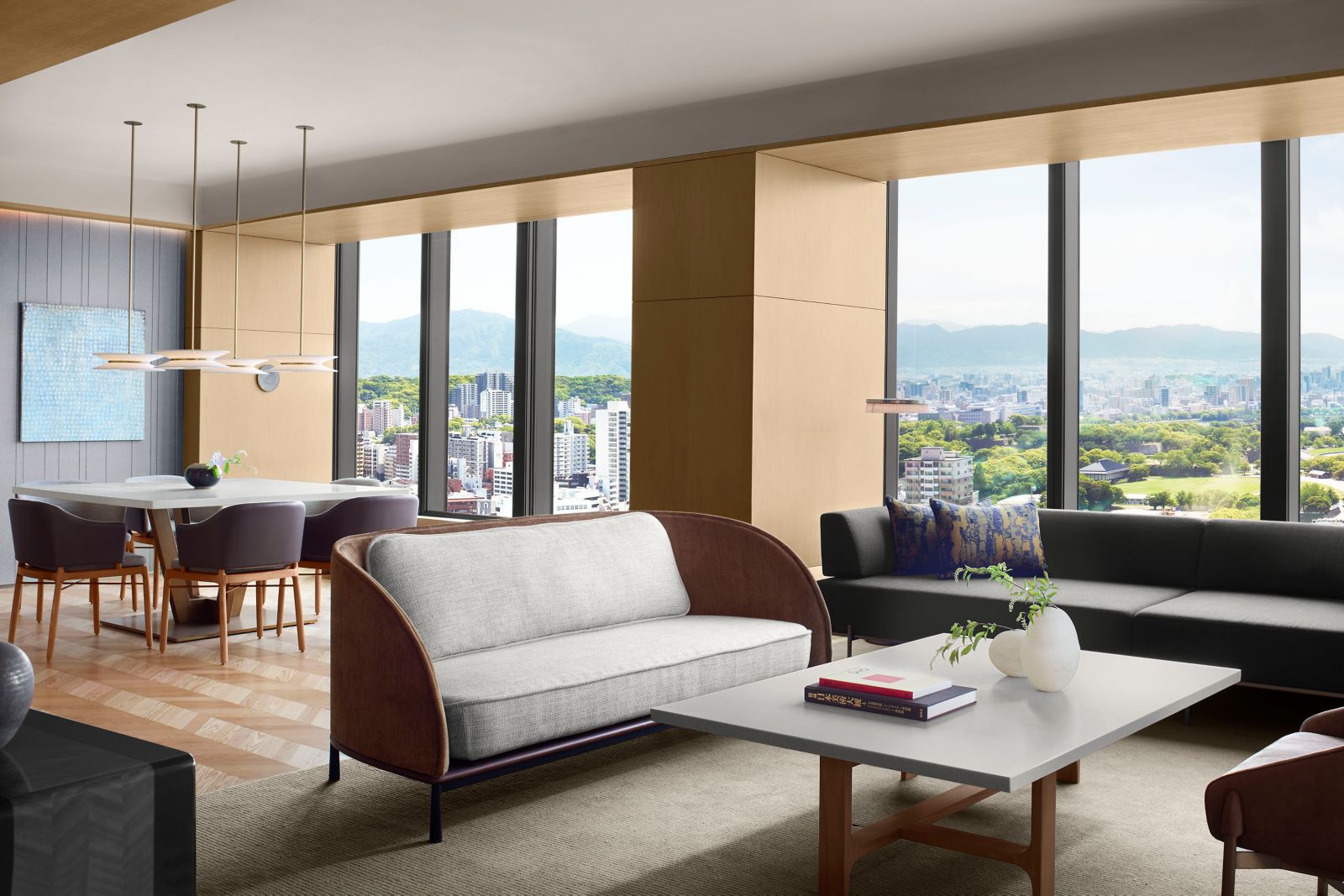 Presidential Suite living room with floor-to-ceiling windows overlooking Ohori Park and Fukuoka mountains