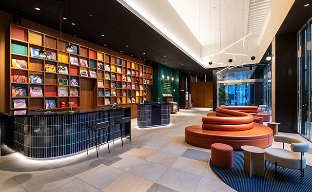 Tokyu Stay Hakata lobby — colorful bookshelf wall and circular reception counter