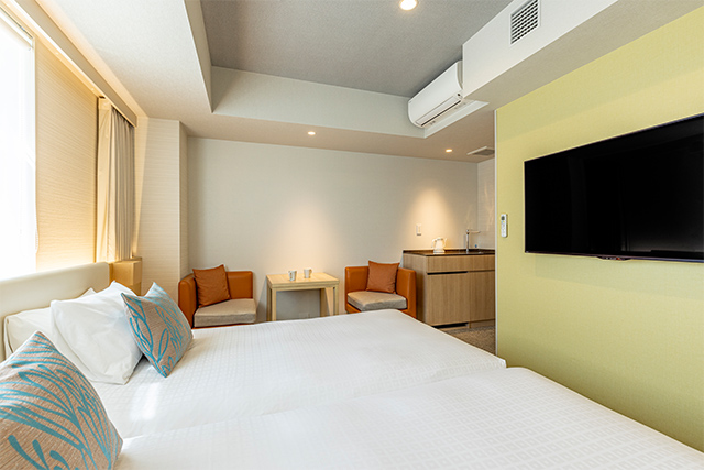 Tokyu Stay Hakata compact double room with yellow-green accent wall