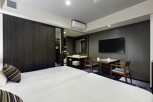 Tokyu Stay Hakata deluxe twin room showing in-room washer-dryer unit