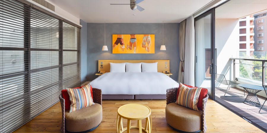 WITH THE STYLE FUKUOKA deluxe room with king bed, art wall, and private balcony